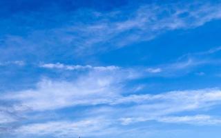 Stunning cirrus cloud formation panorama in a deep blue sky photo