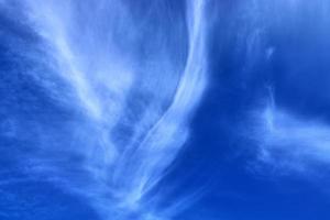 Stunning cirrus cloud formation panorama in a deep blue sky photo