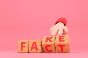 Hand turns dice and changes the word fake to fact. photo