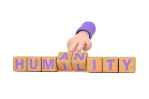 Hand turns dice and changes the word  humanity to humility. photo