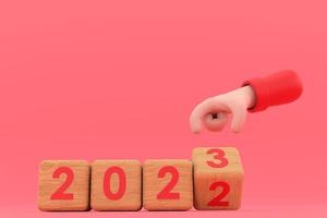 mano y cubos con 2022 - 23. representa el nuevo año 2023 foto