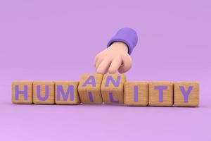 Hand turns dice and changes the word  humanity to humility. photo