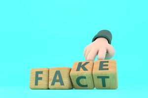 Hand turns dice and changes the word fake to fact. photo