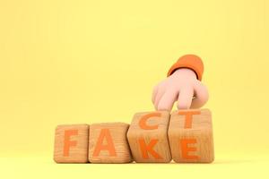 Hand turns dice and changes the word fake to fact. photo