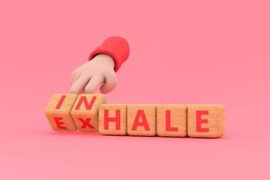 Hand turns dice and changes the word INHALE to EXHALE. Inhale,Exhale concept. photo