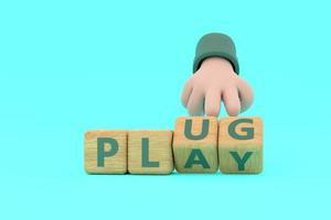 Hand turns dice and changes the word plug to play. photo