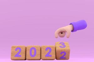 mano y cubos con 2022 - 23. representa el nuevo año 2023 foto