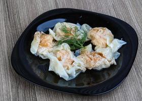 Shrimp wanton on the plate and wooden background photo