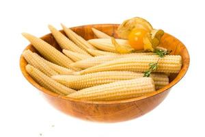 Baby corn in a bowl on white background photo