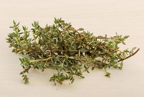 Thyme on wooden background photo