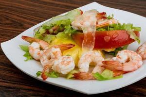 Shrimps with aloe vera salad on the plate and wooden background photo
