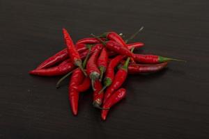 Chili peppers on wooden background photo