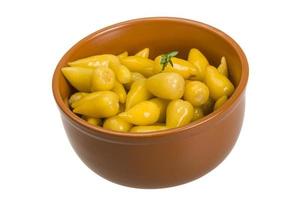 Marinated pepper in a bowl on white background photo