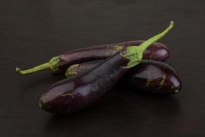 Aubergine on wooden background photo