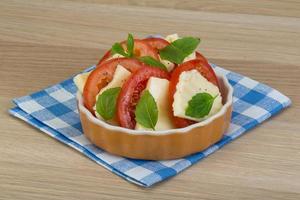 Caprese in a bowl on wooden background photo