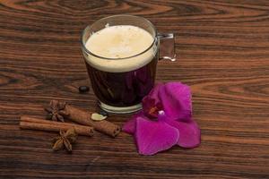 Espresso with orchid on wooden background photo