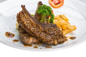 Lamb chops on the plate and white background photo