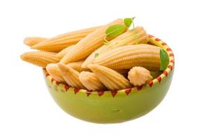 Baby corn in a bowl on white background photo