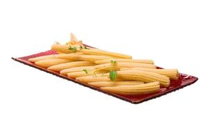 Baby corn on the plate and white background photo