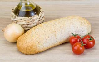 Fresh baguette on wooden background photo