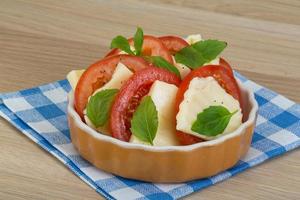 Caprese in a bowl on wooden background photo