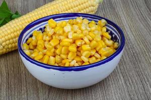 Sweet corn in a bowl on wooden background photo