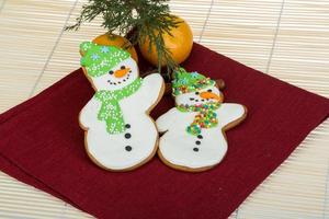 Christmas gingerbread on wooden background photo