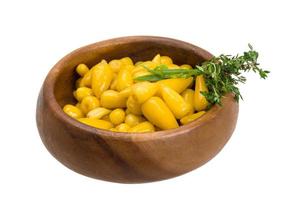 Yellow marinated pepper in a bowl on white background photo