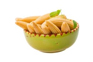 Baby corn in a bowl on white background photo