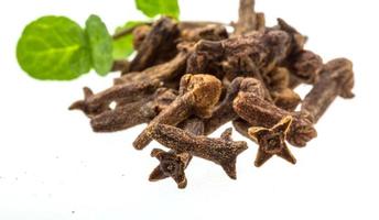 Cloves heap on white background photo