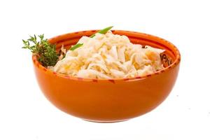 Fermented Cabbage in a bowl on white background photo