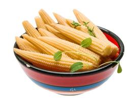 Baby corn in a bowl on white background photo