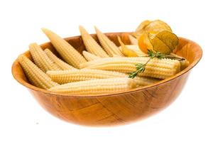 Baby corn in a bowl on white background photo