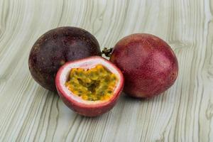 Passion fruit on wooden background photo