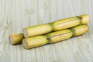 Sugar reed on wooden background photo