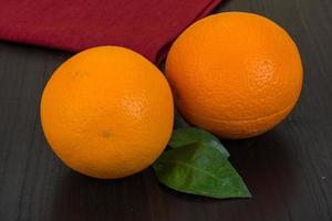 Orange on wooden background photo