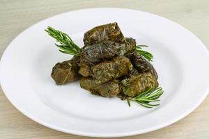 Dolma on the plate and wooden background photo