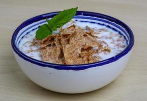 Cornfalkes breakfast in a bowl on wooden background photo