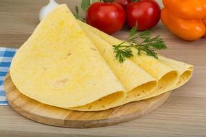 Tortilla on wooden board and wooden background photo