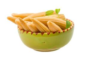 Baby corn in a bowl on white background photo