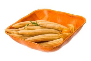 Baby corn in a bowl on white background photo