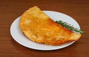 Meat Cheburek on the plate and wooden background photo