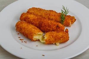 Fried cheese on the plate photo