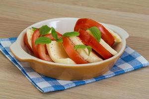 Caprese in a bowl on wooden background photo