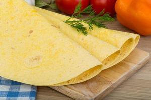 Tortilla on wooden board and wooden background photo