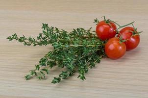 Fresh thyme on wooden background photo