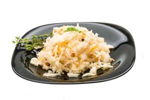 Fermented Cabbage on the plate and white background photo