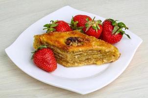 Baklava on the plate and wooden background photo