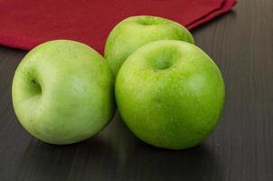 Green apple on wooden background photo