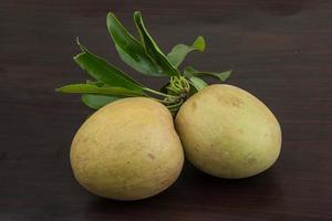 Sapodilla on wooden background photo